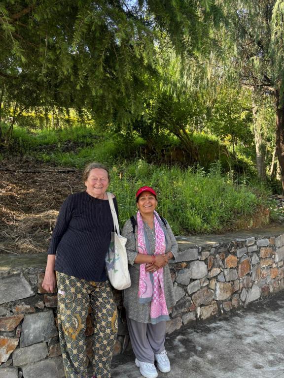Mira with a guest outside Mums Homestay