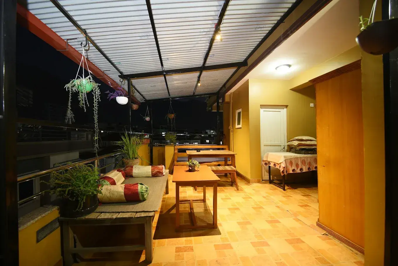 Covered rooftop terrace with tables and relaxed seating